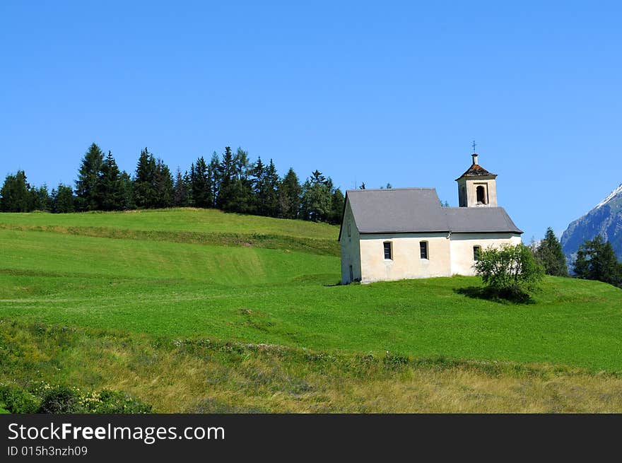 Picturesque landscape featuring an old church in the swiss alps. Picturesque landscape featuring an old church in the swiss alps