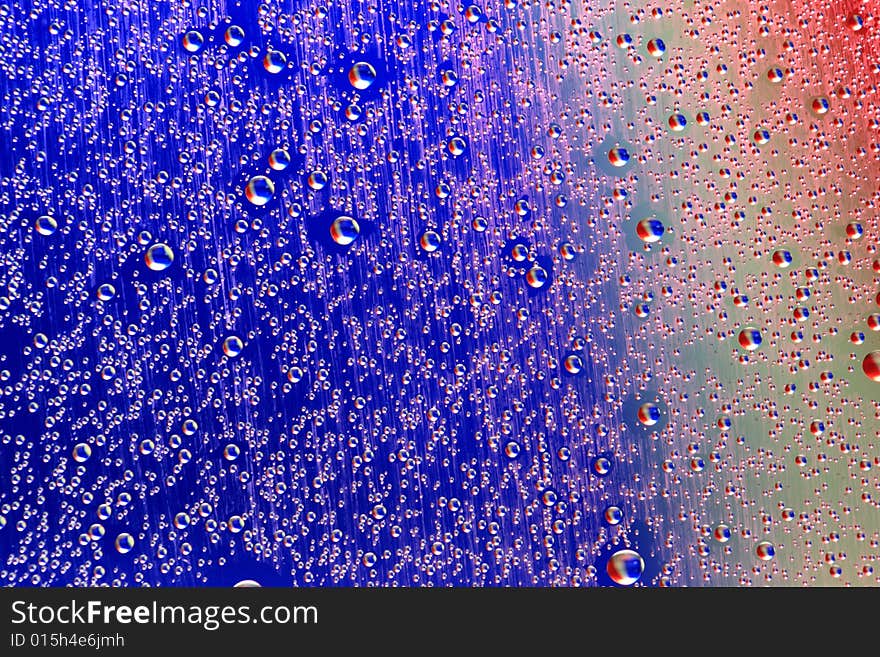 Drops of water on a blue, lila background. Drops of water on a blue, lila background.