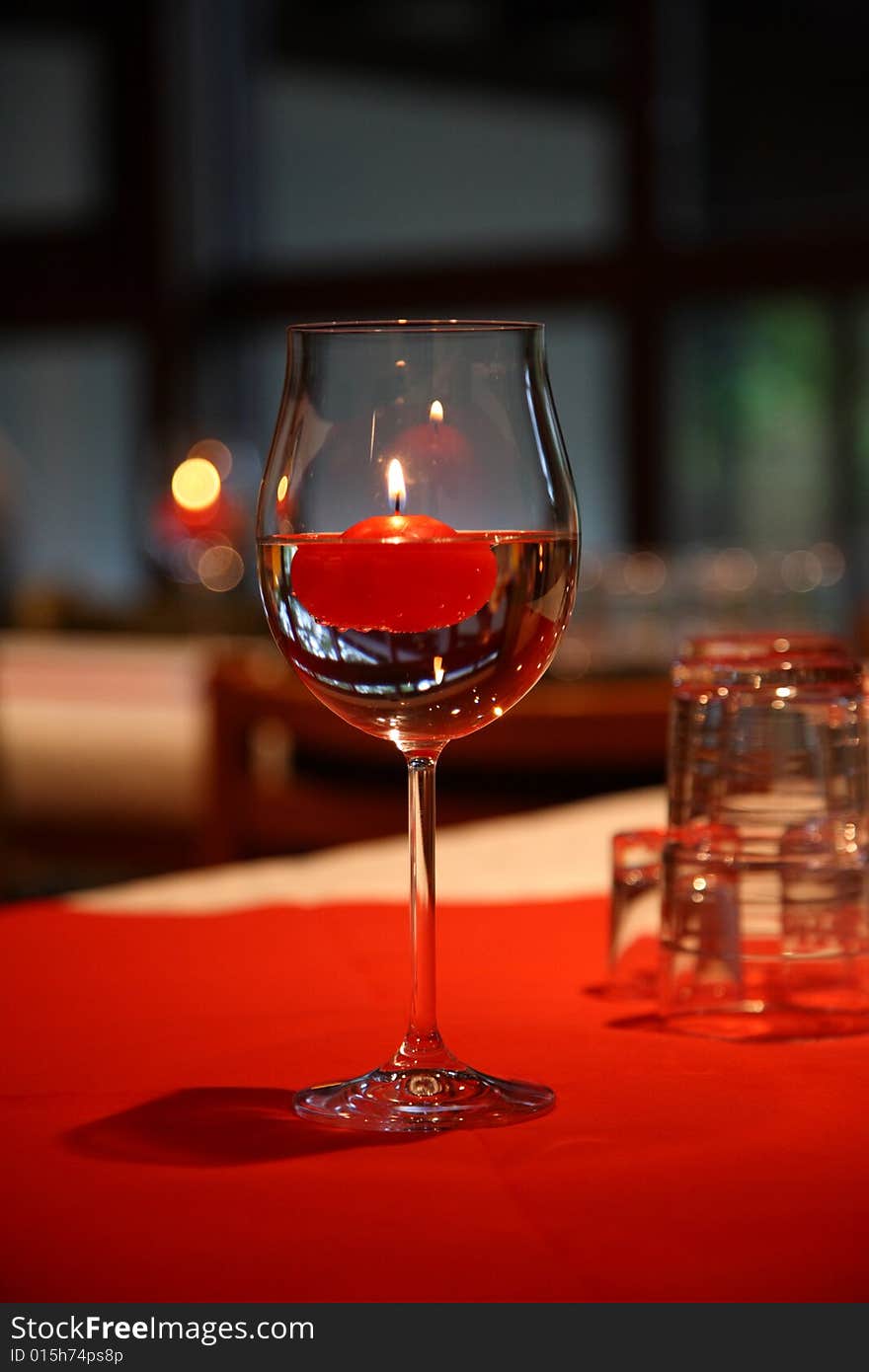 Glass for wine with a red candle. Glass for wine with a red candle.