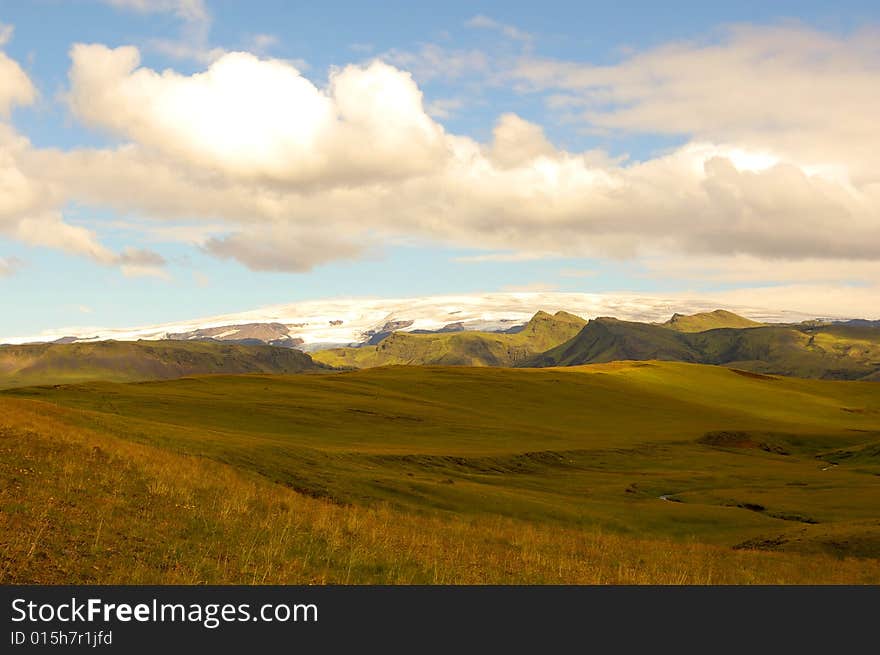 Glacier with a grassland in the foreground