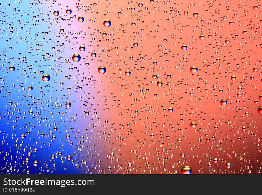 Drops of water on a blue, lila background. Drops of water on a blue, lila background.