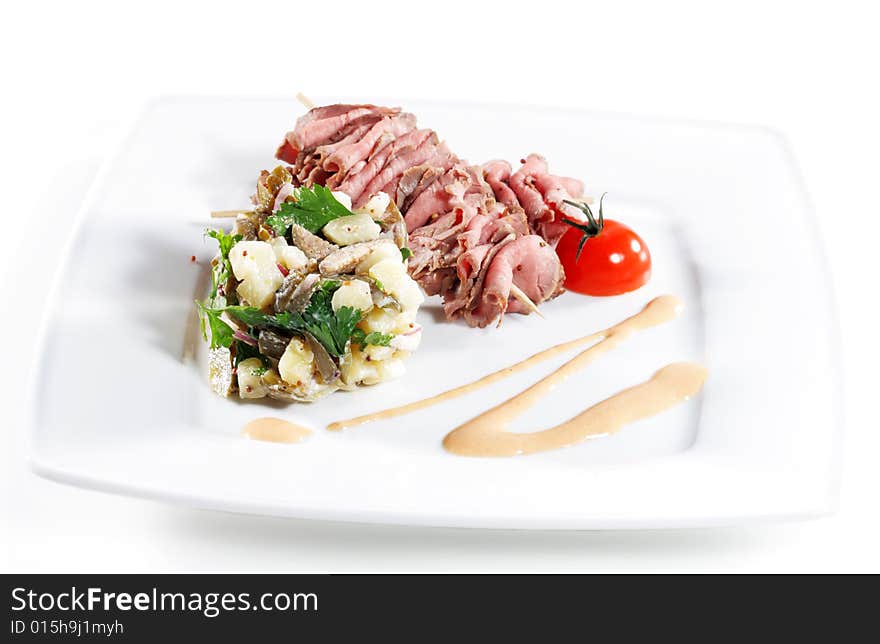 Roast Beef Served with Salad (Potatoes and Vegetables) and Cherry Tomato. Isolated on White Background