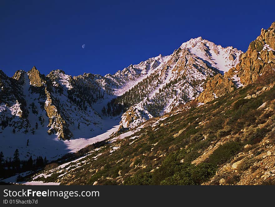 Snowy mountain peak with moon. Snowy mountain peak with moon