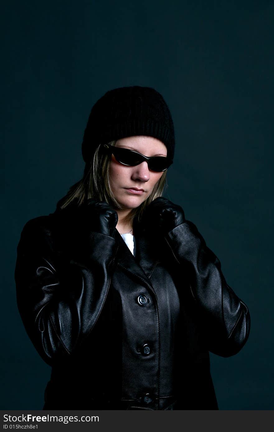 Mysterious woman in dark sunglasses, and black leather. Mysterious woman in dark sunglasses, and black leather.