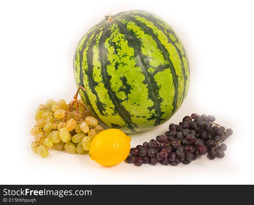 Watermelon and grapes with a lemon fruit on white background. Watermelon and grapes with a lemon fruit on white background