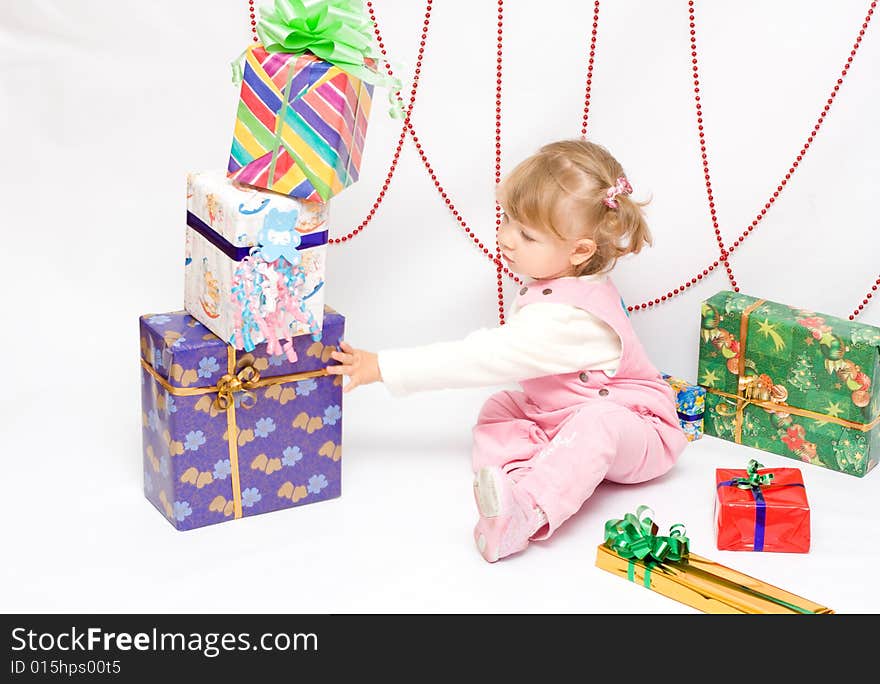 Happy infant with gifts in the decorated christmas box;