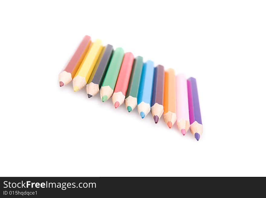 Closeup of a row of bright color pencils. Isolated on white. Closeup of a row of bright color pencils. Isolated on white.