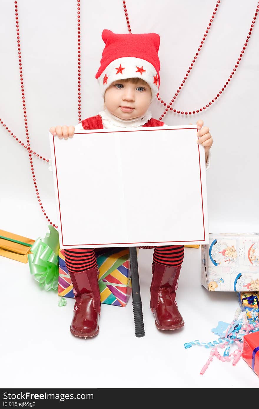 Happy infant with gifts in the decorated christmas box;