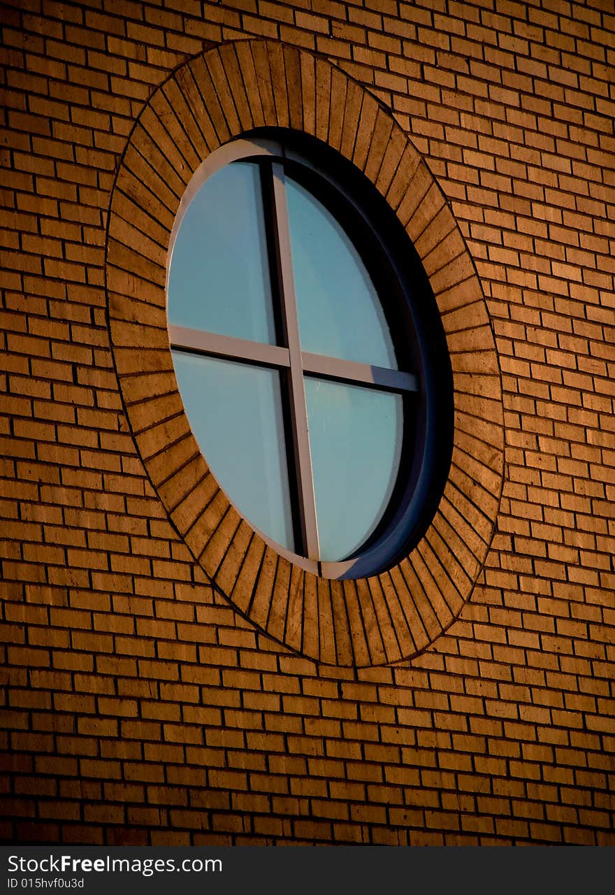 A circular window on a brick building. A circular window on a brick building.