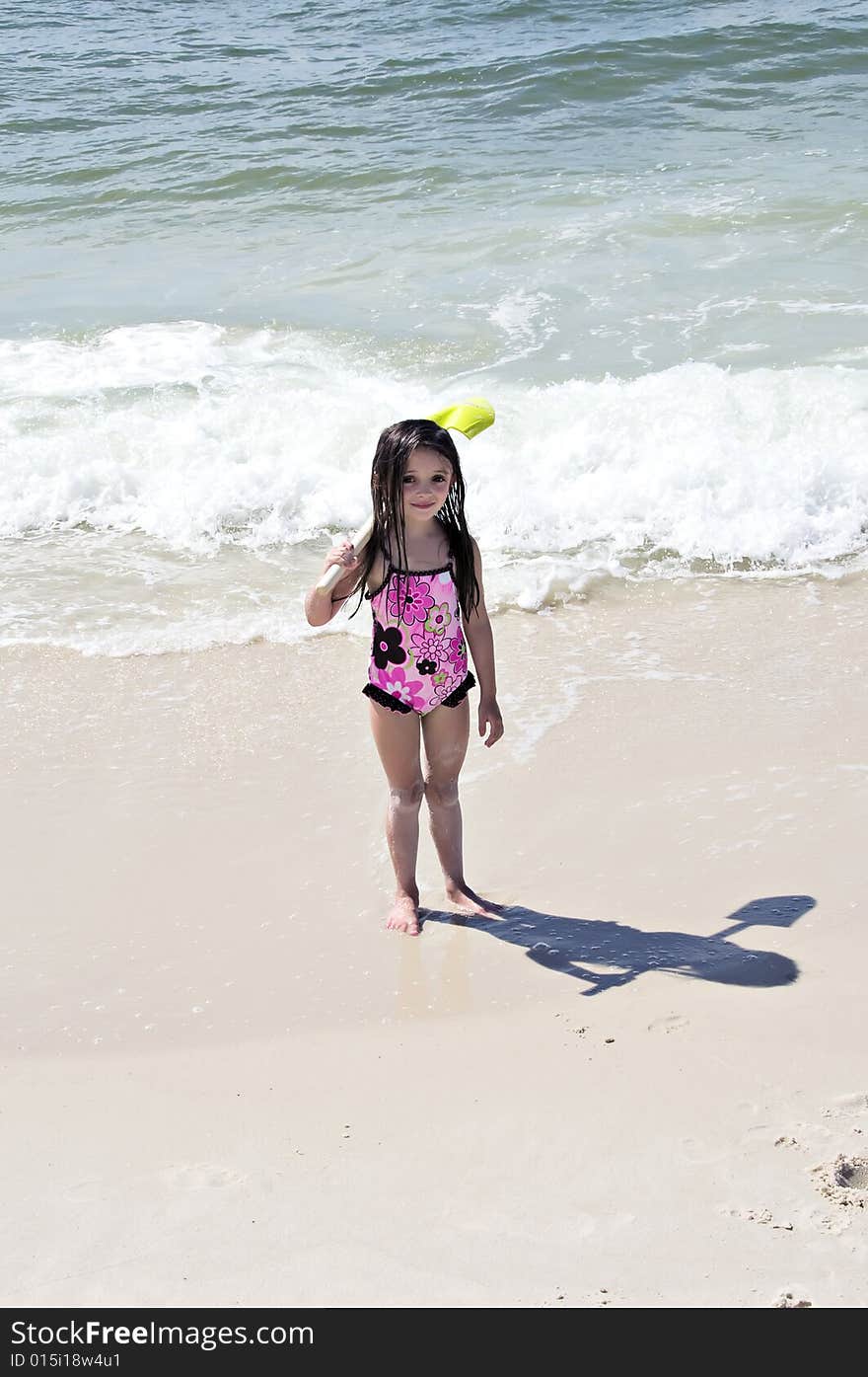 Girl With Shovel On Beach