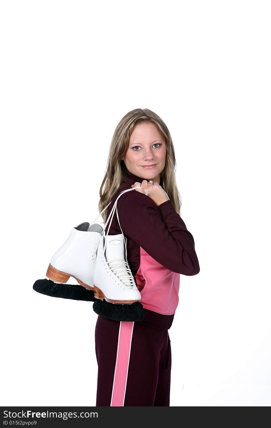 Pretty woman in pink holding her figure skates over her shoulder like she's heading to practice. Pretty woman in pink holding her figure skates over her shoulder like she's heading to practice