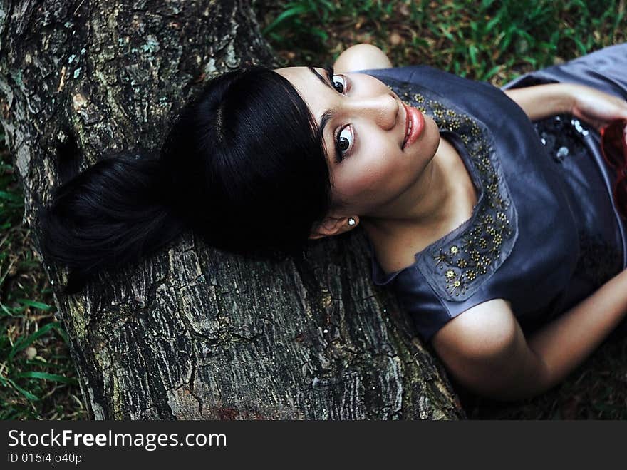 Glamorous beautiful young asian woman lying down