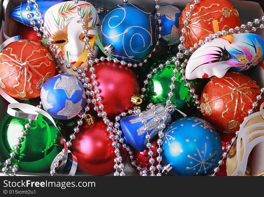 Colorful christmas bulbs, mask, beads and streamer