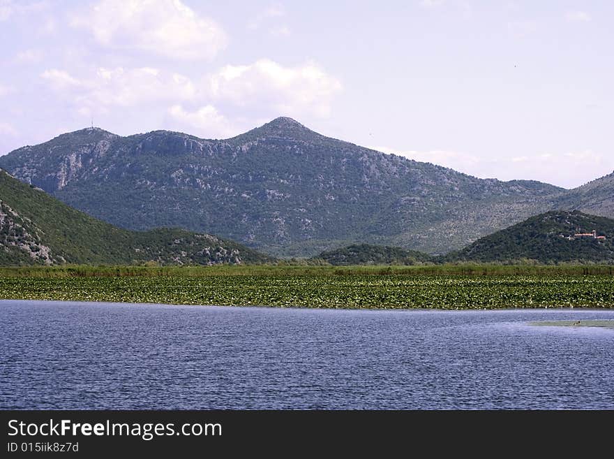 Nice picture of european lakewith water lilies near the mountains. Nice picture of european lakewith water lilies near the mountains