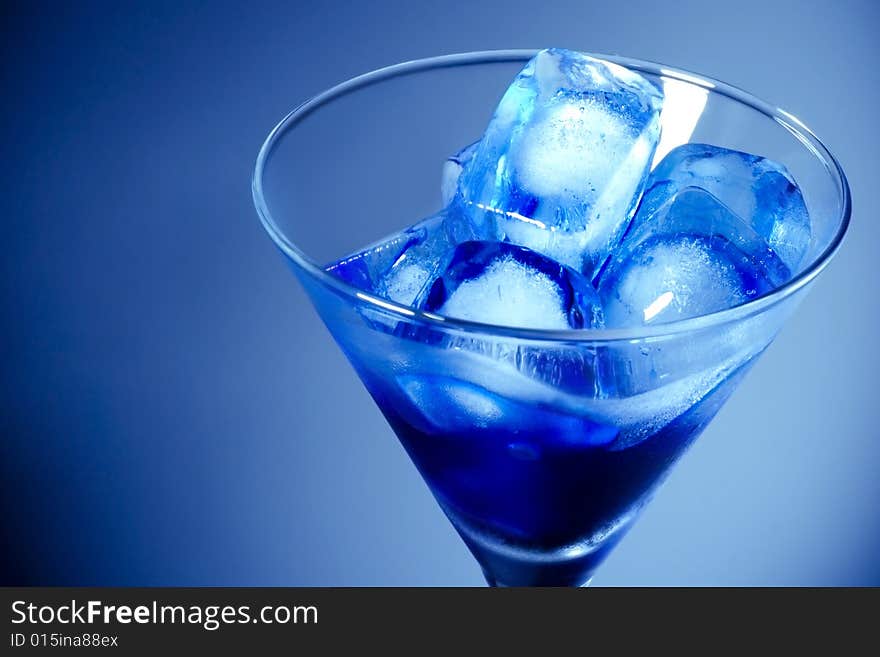 Ice Cube in Martini Glass with blue gradient background