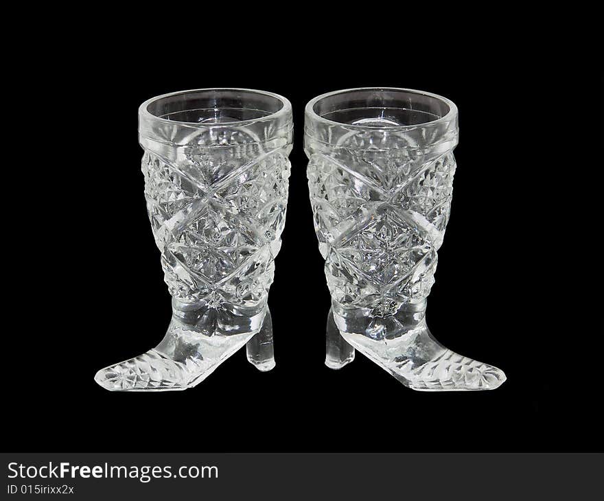 Two wine-glasses from crystal isolated on a black background