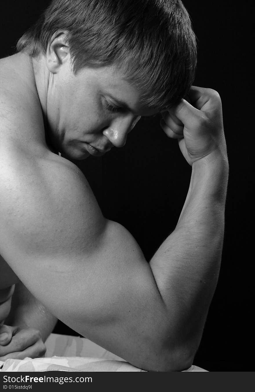 muscular man sitting on chair. muscular man sitting on chair.