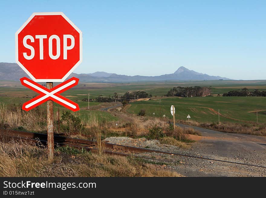 A stop sign at a rail road crossing