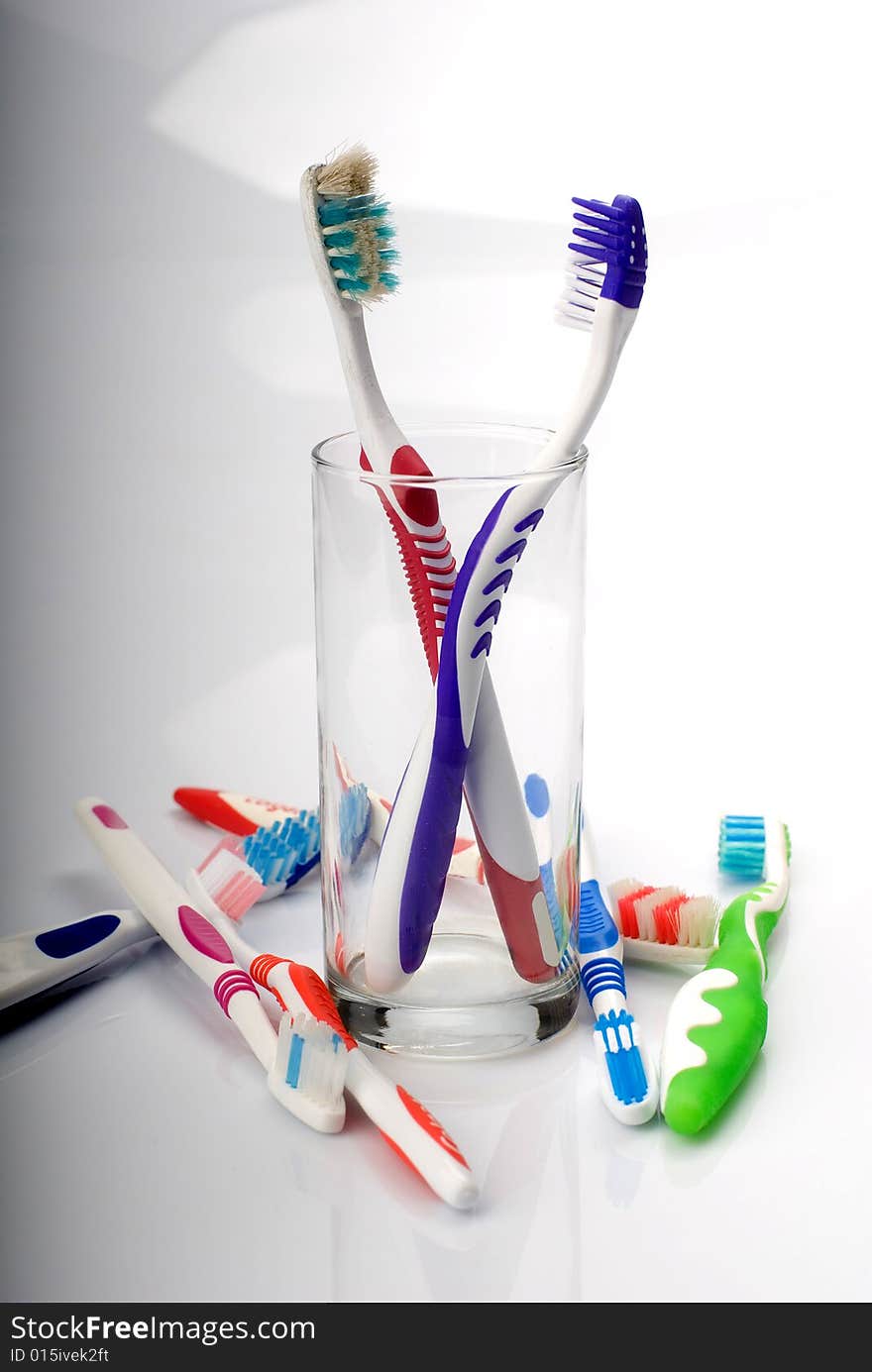 New and old toothbrushes in glass