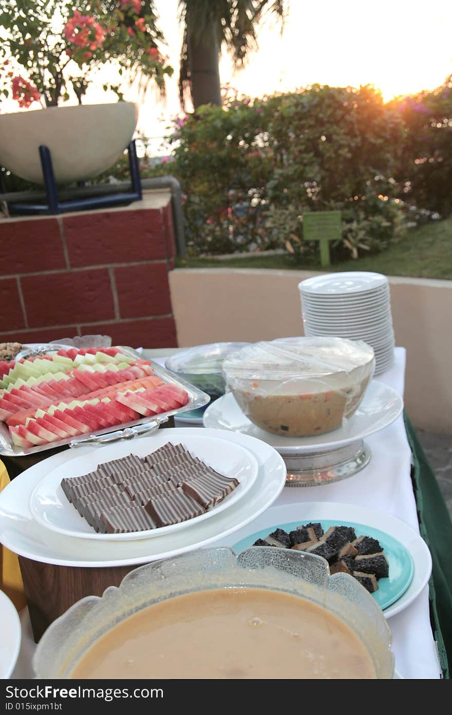 Dessert at buffet sunset at background