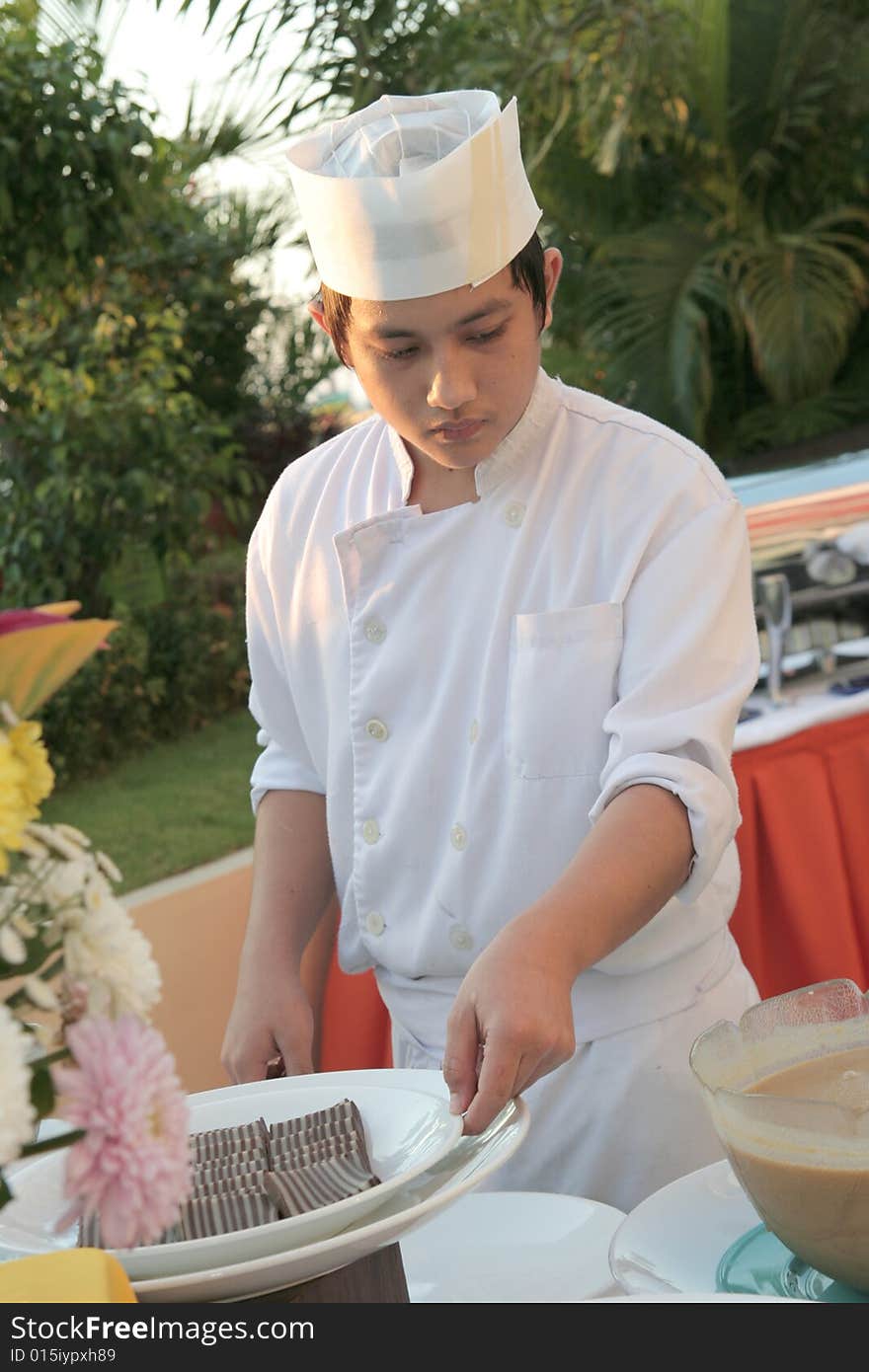 Chef holding pastry food at buffet. Chef holding pastry food at buffet