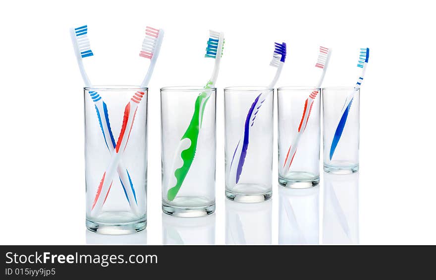 New toothbrushes in glasses, isolated