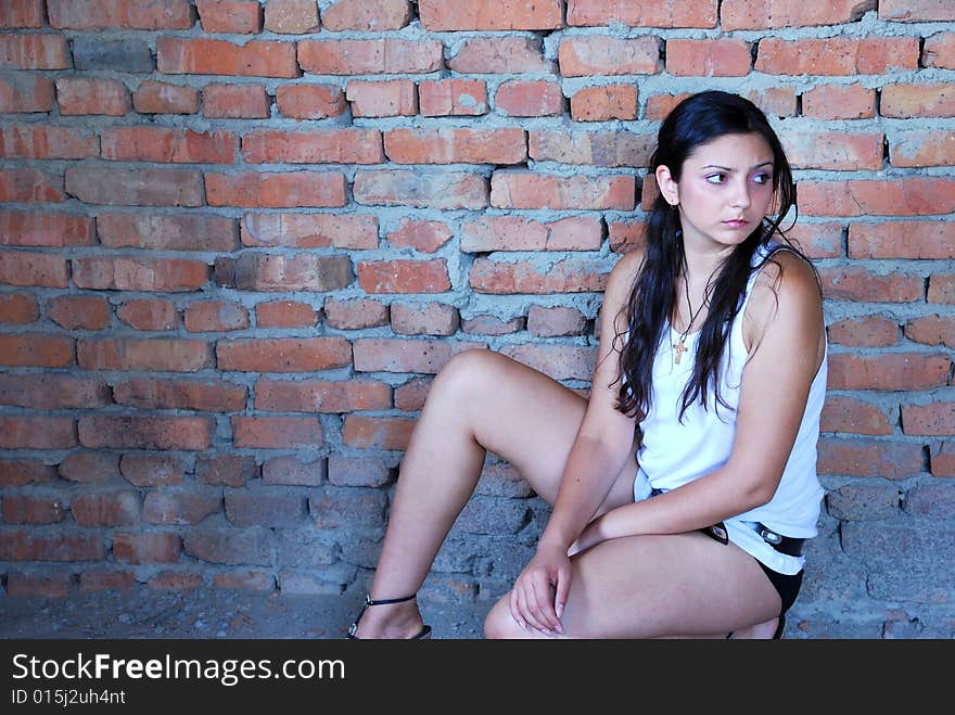 The girl near a brick wall