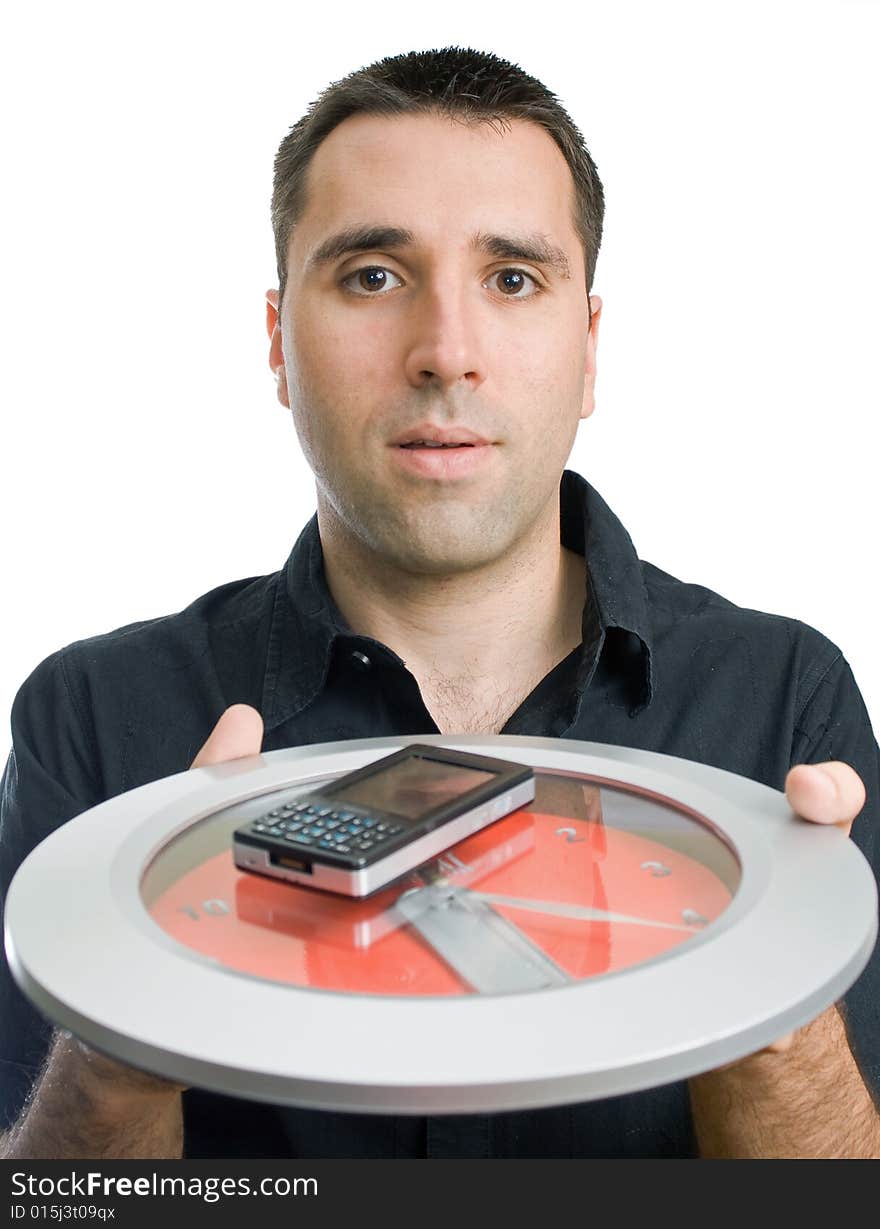 Young man, holding a cellphone on a clock, reaching forward. Young man, holding a cellphone on a clock, reaching forward