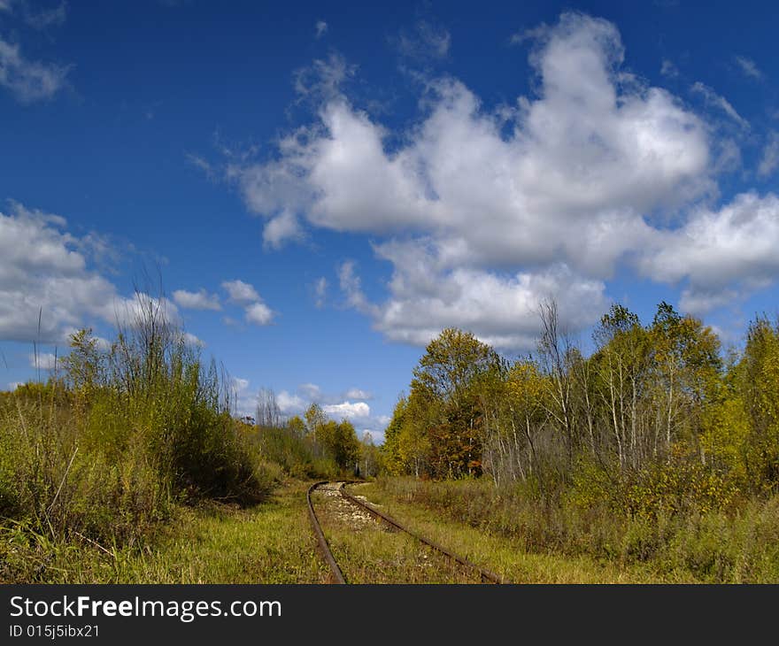 A summer landscape with an old railway track