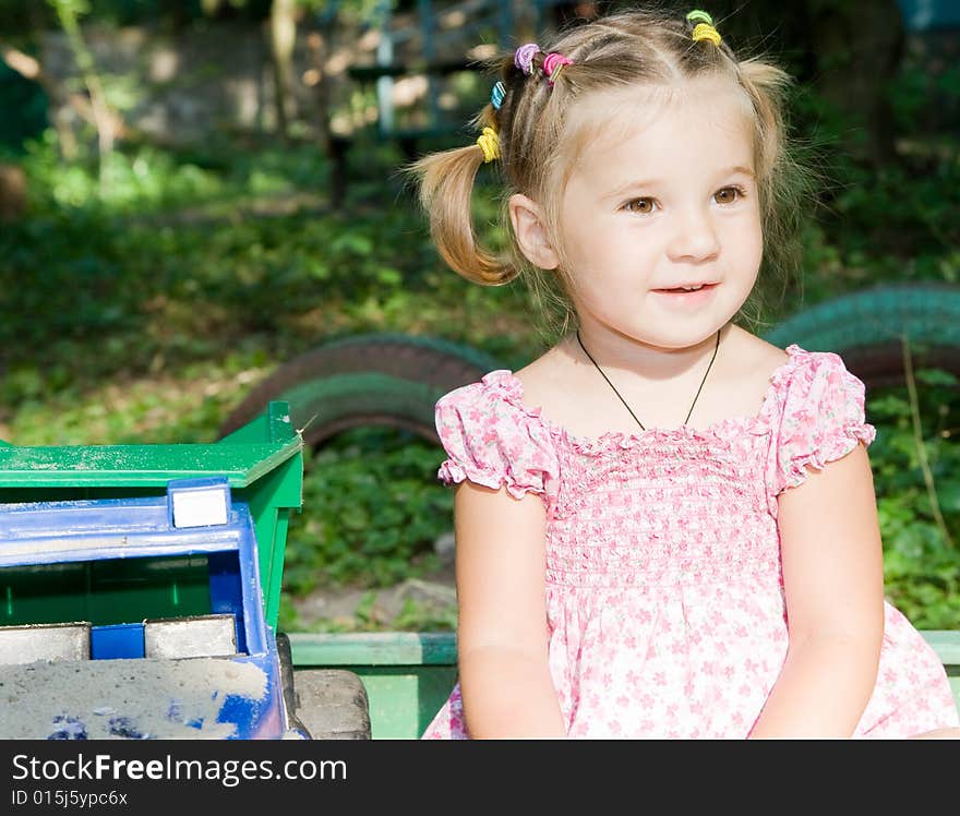 Little girl playing in sandbox