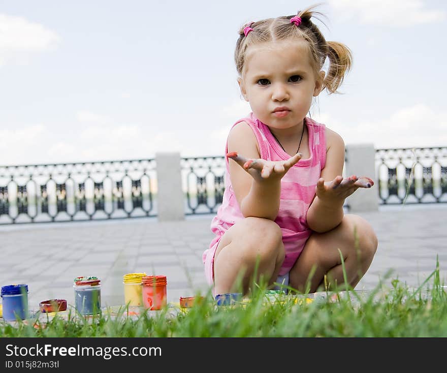 Little girl playing with paints