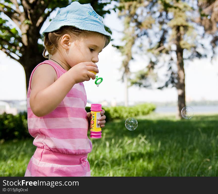 Portrait of girl blowing bubbles