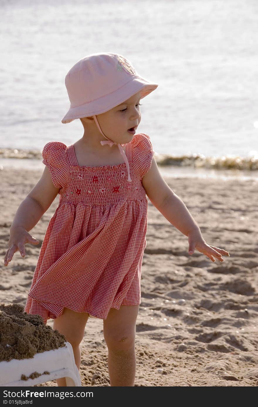 Little girl with red dress on the beach. Little girl with red dress on the beach