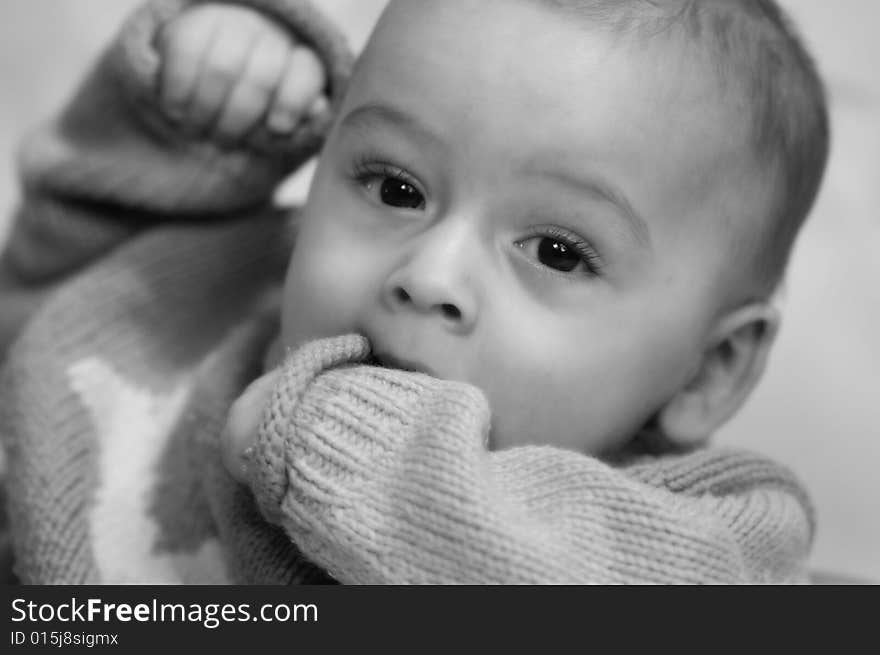 Beautiful baby boy Teething on his hand