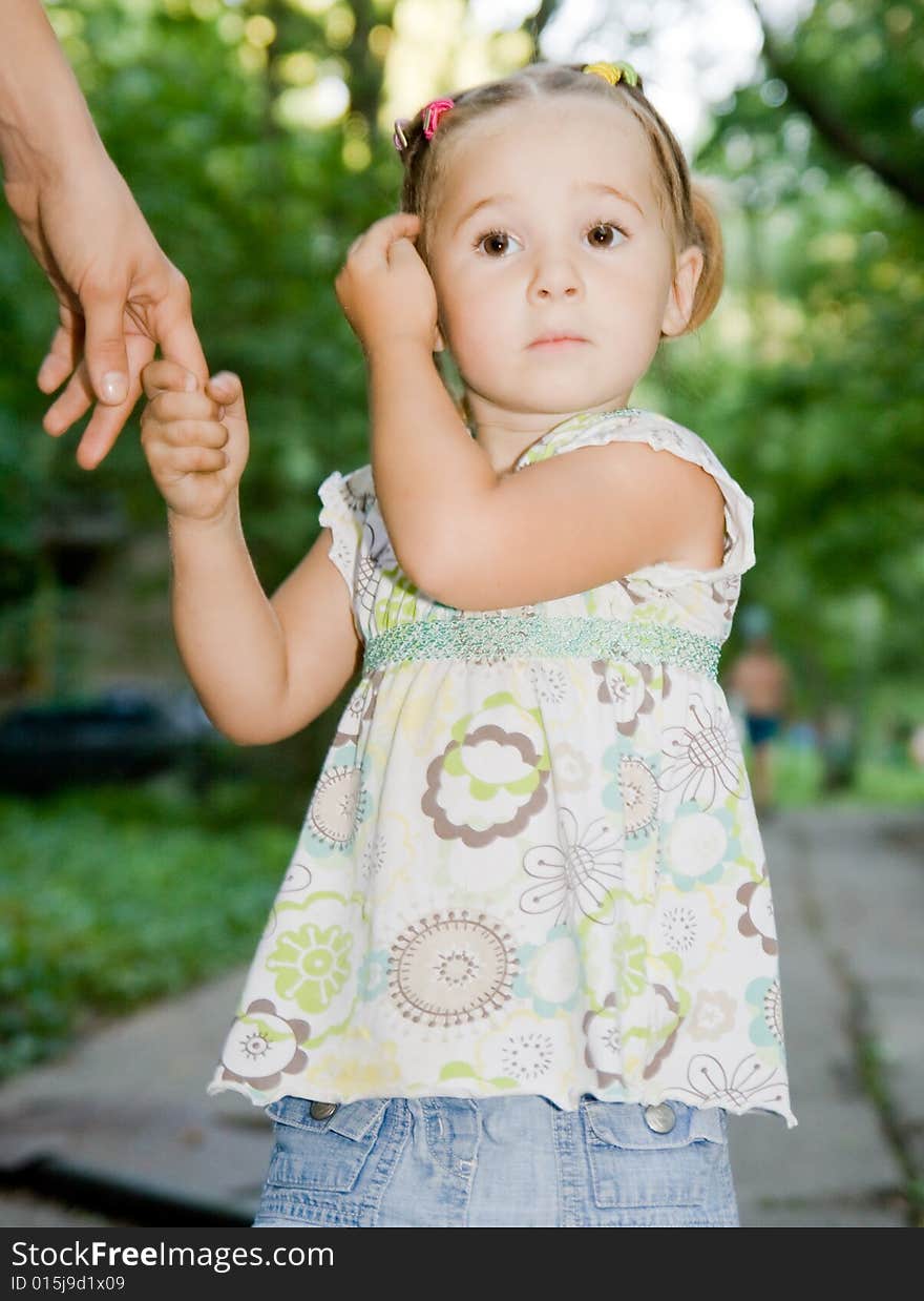 Little girl with mother hand outdoor