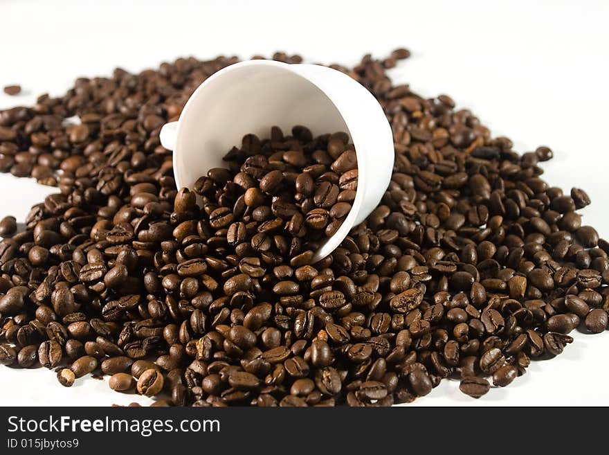 White cup with coffee beans (on white background)