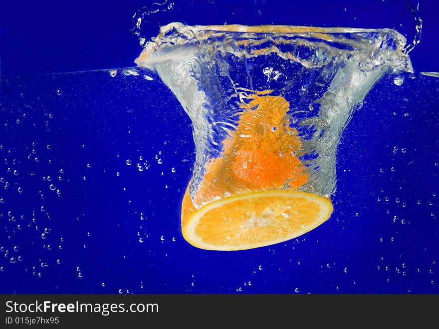 A fresh orange under water. A fresh orange under water