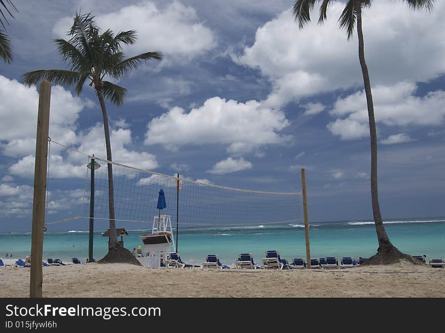 Resort scene showing sand volley ball court and beach beyond. Resort scene showing sand volley ball court and beach beyond