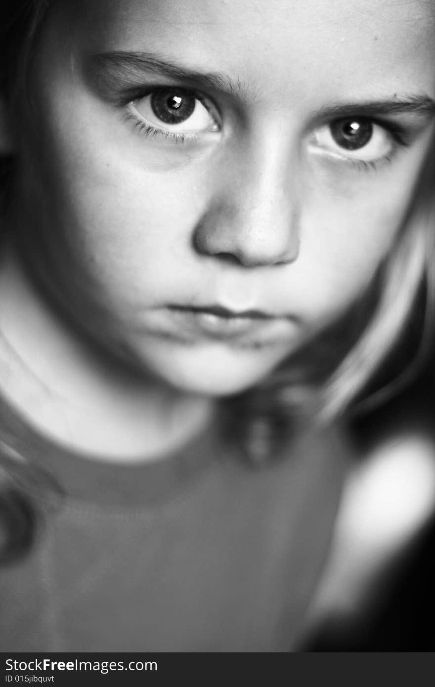 Portrait of boy in black and white with big eyes.