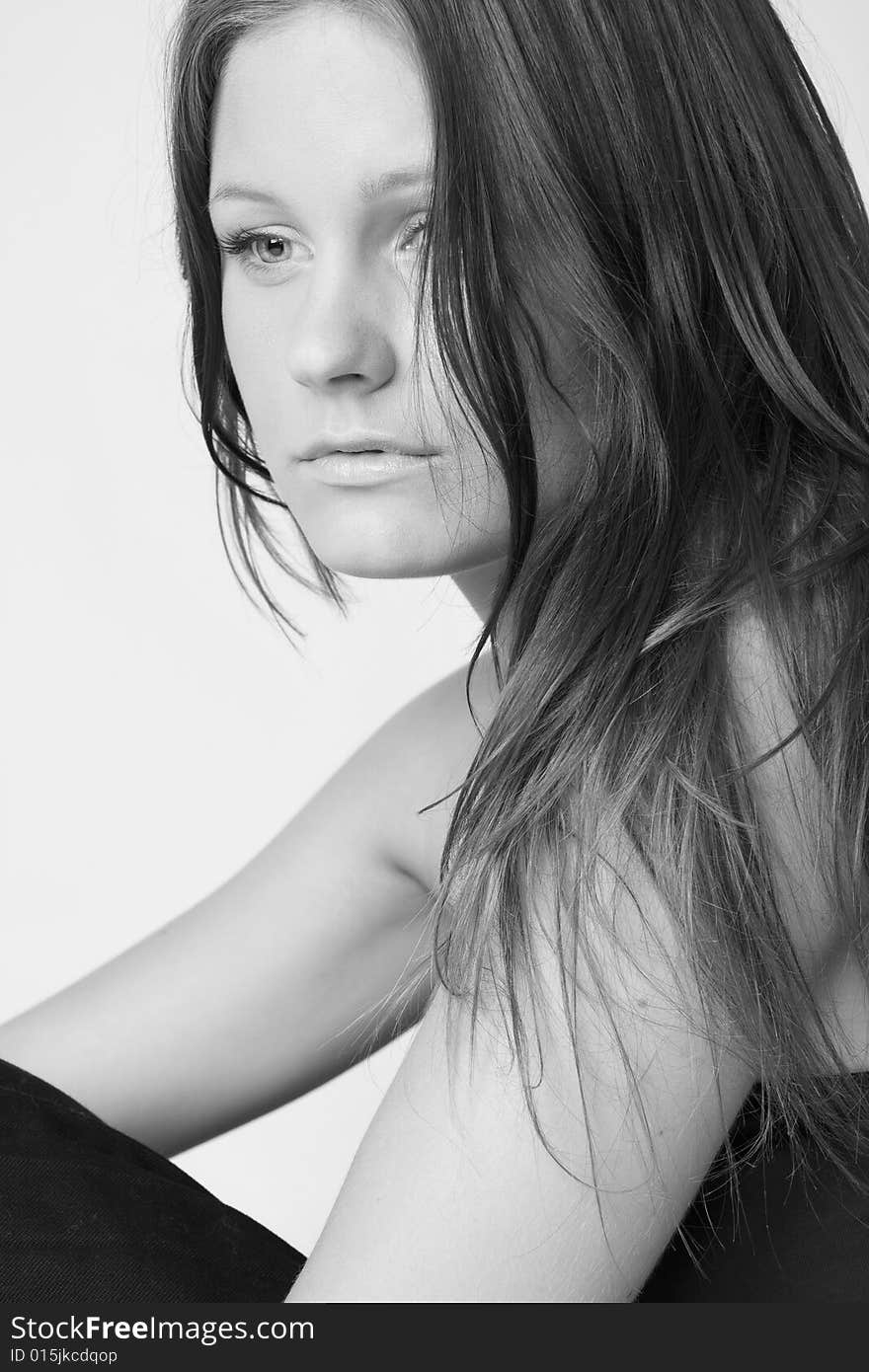 Portrait of young beautiful sad woman on white background