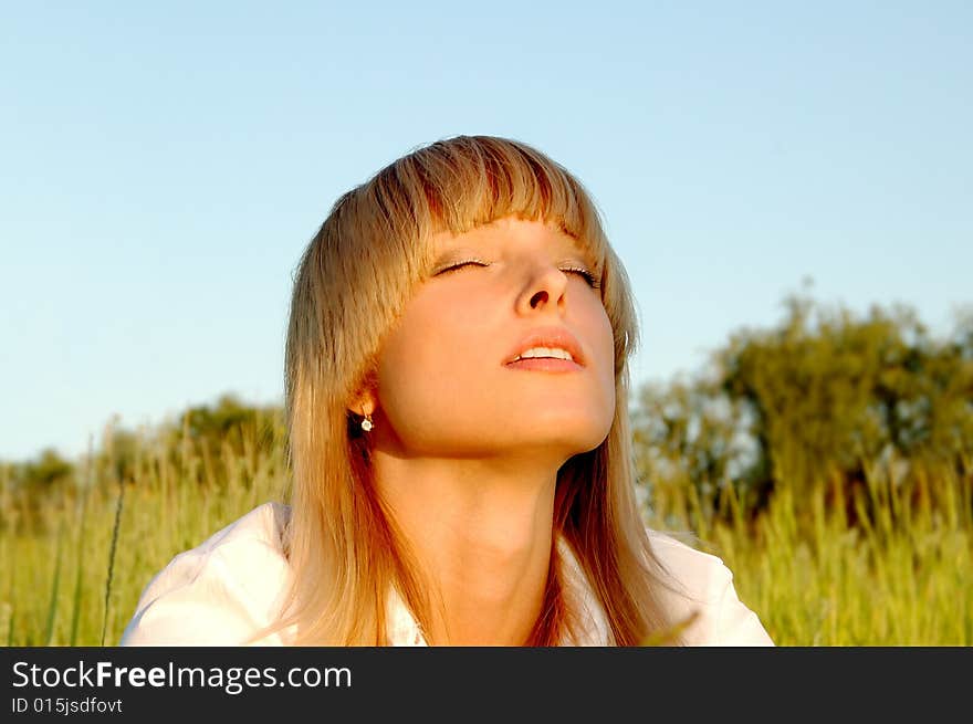 Beautiful young woman enjoy the sun outdoors