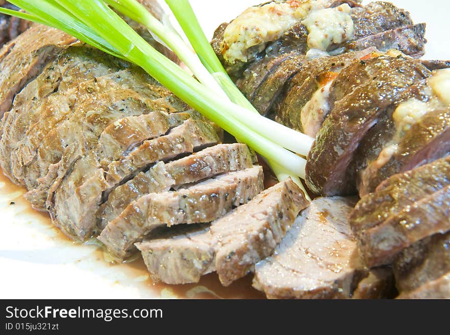 Delicious sliced fillet steak of a Kudu, medium done and served on a plate.