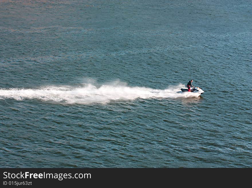 Man is driving a water-bike. Man is driving a water-bike