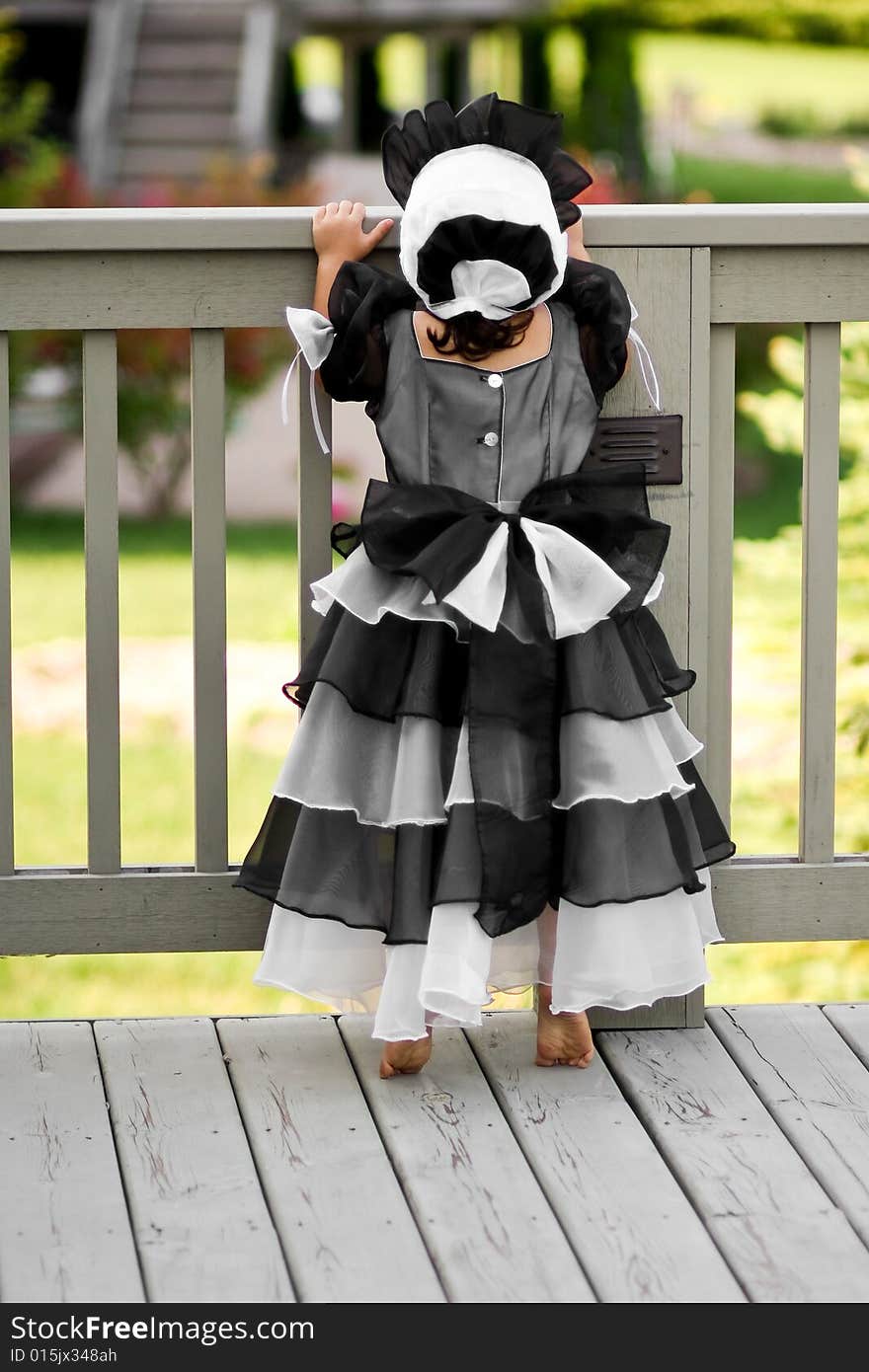 Cute little princess dressed in an old style english dress with a bonnet for halloween. Cute little princess dressed in an old style english dress with a bonnet for halloween