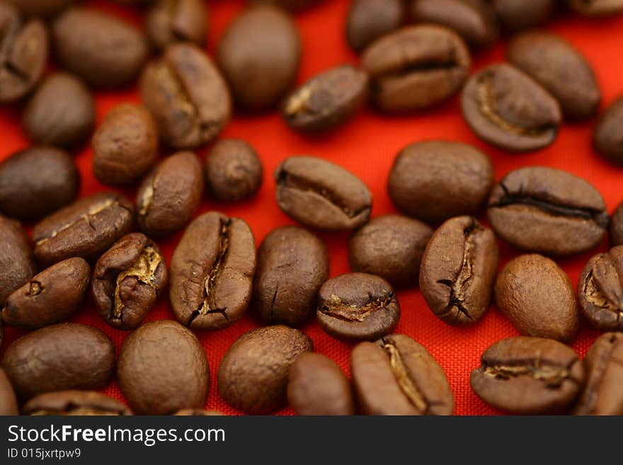 Coffee beans on red background