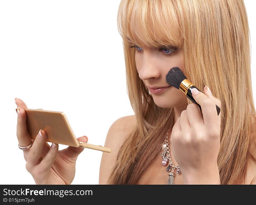 Portrait of a beautiful blonde woman with light blue eyes applying make-up isolated on white background. Portrait of a beautiful blonde woman with light blue eyes applying make-up isolated on white background