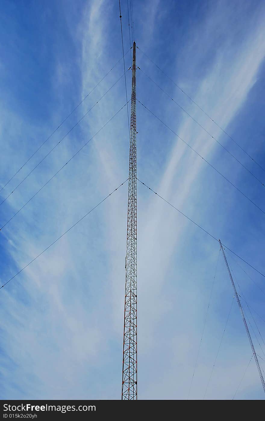 Wide angel shot of a radio tower from below in the blue sky. Wide angel shot of a radio tower from below in the blue sky.