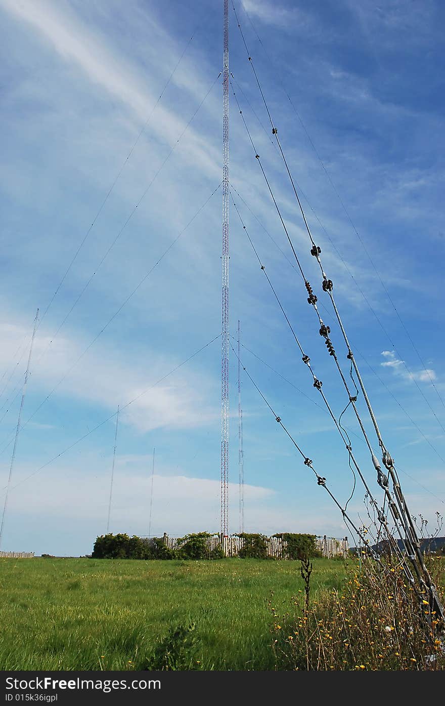 Wide angel shot of a radio tower from below in the blue sky. Wide angel shot of a radio tower from below in the blue sky.