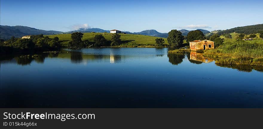 A lonely ruin house near a quiet lake. A lonely ruin house near a quiet lake