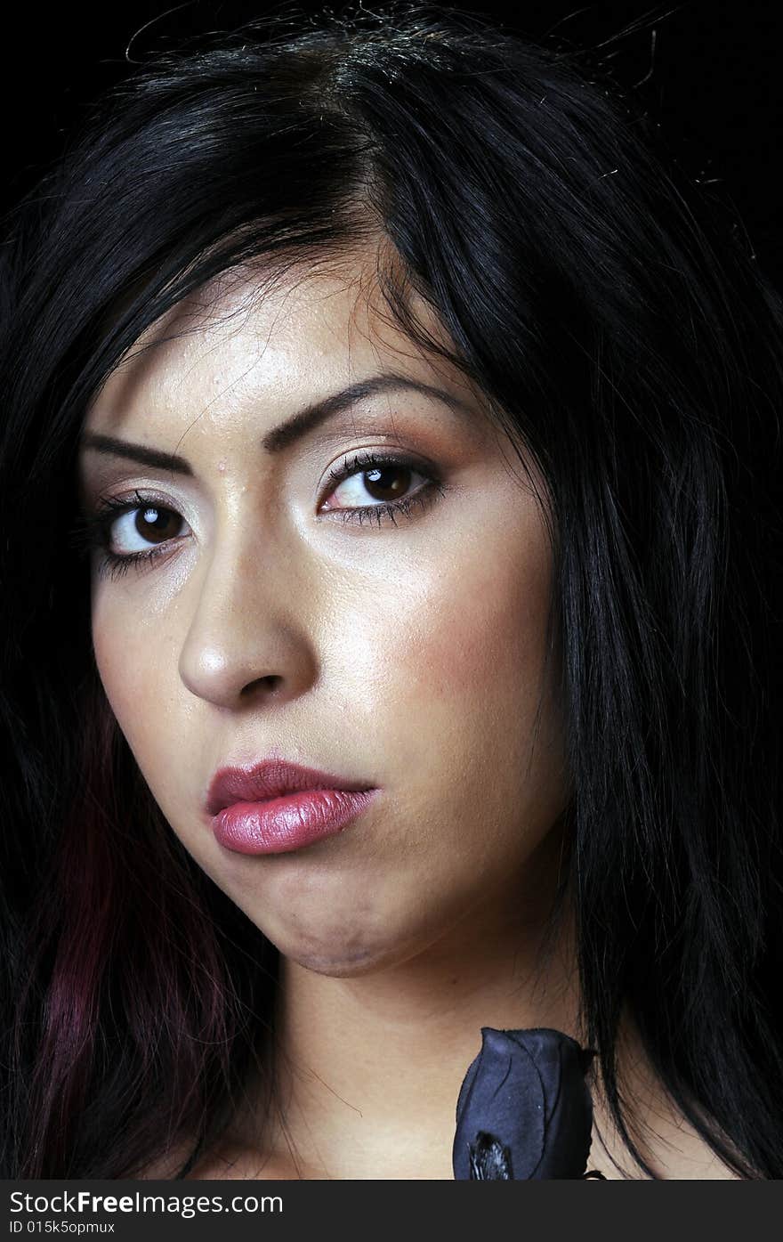 Beautiful young Hispanic brunette woman with a black rose in closeup. Beautiful young Hispanic brunette woman with a black rose in closeup